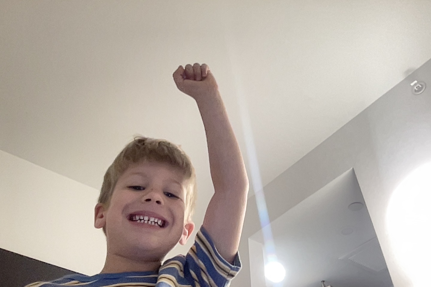 Jordy smiling with one arm raised